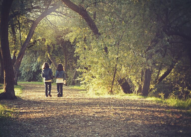 people walking together along a park path in the morning